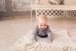 Little baby boy crawling on the floor at home