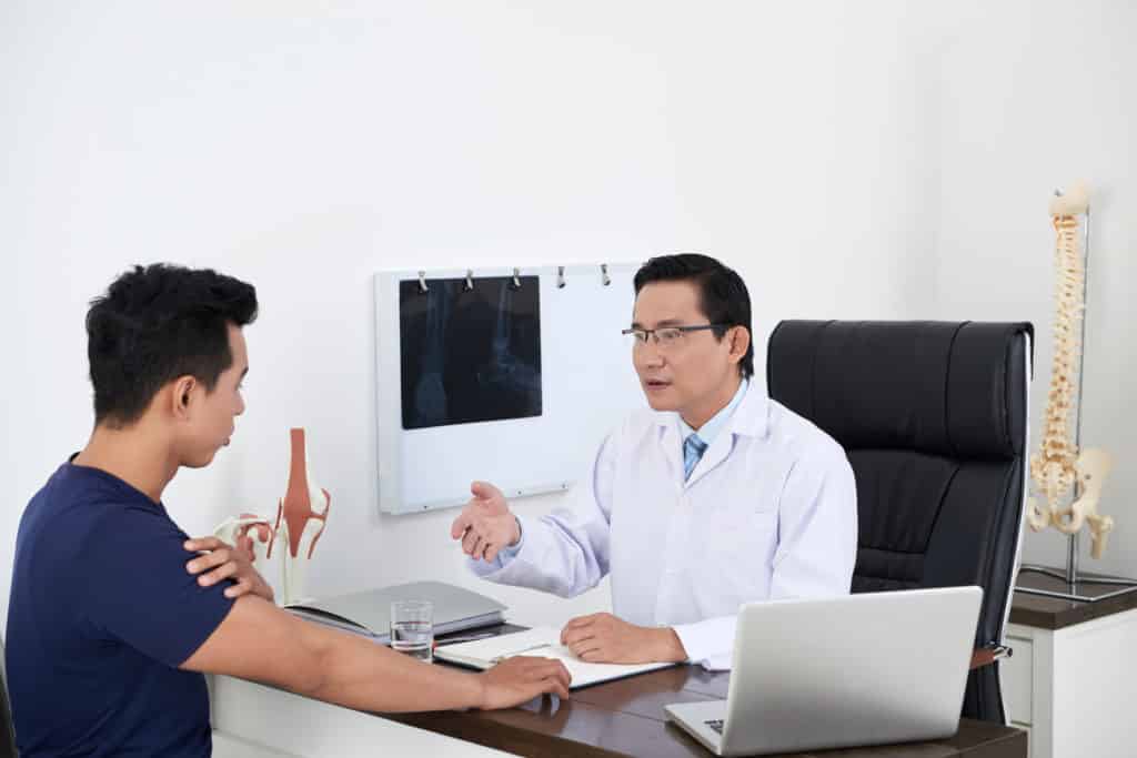 Chiropractor asking about sciatica symptoms